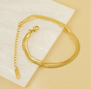 Detailed close-up of 18K gold-plated stainless steel snake and bead double-layer anklet