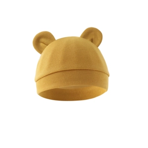 Detail of mustard yellow ribbed cotton baby beanie with cute bear ear decorations