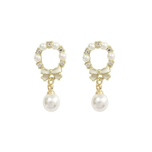 Detail view of pearl bow earrings with white enamel and sparkling teardrop drop pearls