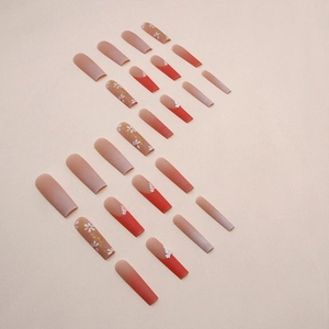 Matte autumn orange long coffin press-on nails with floral art and gold foil accents