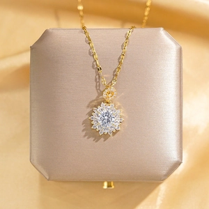 Luxury gold sunflower necklace with sparkling zircon pendant on champagne satin display box