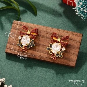 Detailed view of Christmas bow earrings with pearls and crystals on a festive background