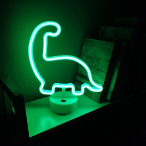 Close-up of green dinosaur neon light on white base creating a cozy bedroom atmosphere