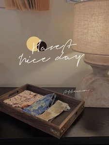 Three-piece printed fabric storage pouches in a rustic wooden tray for home organization