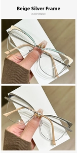 Macro detail of cream and silver cat-eye glasses frame with metallic browline design