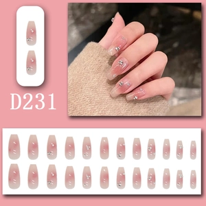 Detail of pink gradient press-on nails with pearls, crystals and 3D bow decorations