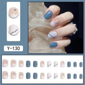 Short square press-on nails in blue and white with gold trim and abstract patterns