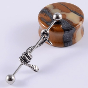 Detailed view of stainless steel industrial barbell earring with a snake wrap design