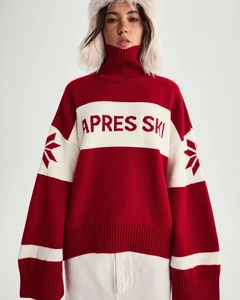 Detail of red and white knit sweater featuring large APRES SKI jacquard lettering on chest