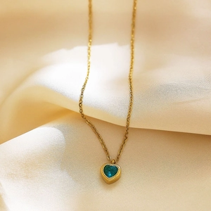 Detailed macro view of 18k gold plated necklace with blue heart-shaped zircon pendant