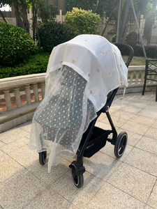 Detail of stroller mosquito net with peach and flower patterns for sun protection