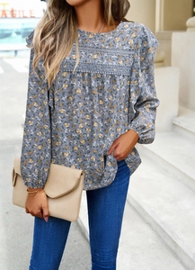 Close-up of gray-blue floral shirt featuring lace stitching and ruffle detailing