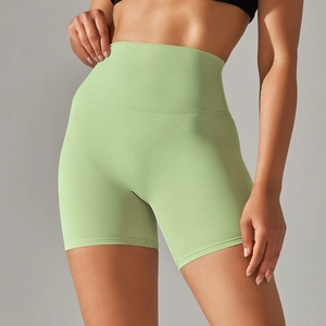Detail of high-waist lemon green yoga shorts showing seamless fabric and ergonomic fit