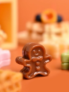 Detailed macro shot of a brown gingerbread man resin miniature for DIY craft and decor