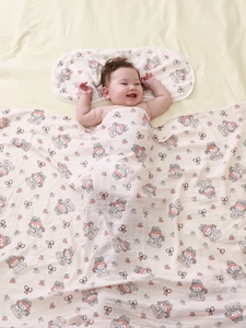 Detailed view of bamboo cotton baby blanket with cartoon prints and soft matching pillow