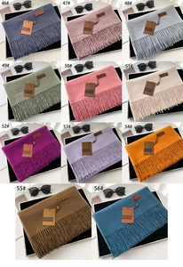 Grid view showcasing eleven assorted solid colors of long fringed cashmere-like scarves