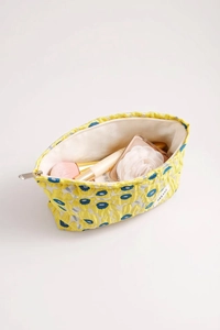 Detail of floral jacquard makeup bag showing interior storage capacity and zipper