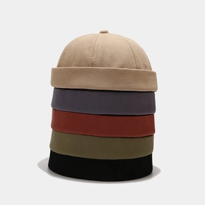 Detail showing various colors and cotton twill texture of these retro brimless dock caps