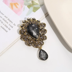 Vintage bronze brooch with large black teardrop crystal and pave diamond flower petals