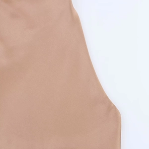 Detailed close-up showing the smooth satin texture and fabric of this beige halter top