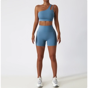 Détail du haut de yoga bleu à une épaule et du short à taille haute avec découpes