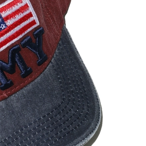 Macro detail of 3D flag embroidery and distressed denim brim on the baseball cap