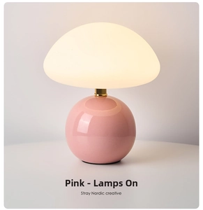 Detail of mushroom lamp with pink ceramic base and warm white frosted glass shade