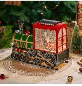Macro detail of Christmas train snow globe with Santa inside and festive decorations