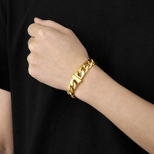Detail of 13mm gold titanium steel curb chain necklace on model with high gloss finish