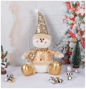 Detail of sequined white Christmas snowman doll with gold hat and scarf decoration