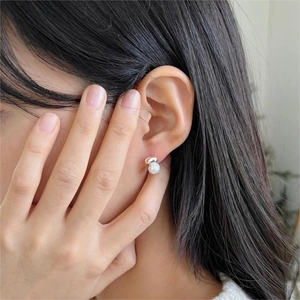 Elegant 925 sterling silver pearl stud earrings shown on model for a minimalist look