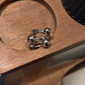 Detail view of a silver stainless steel multi-layer ring with spherical bead accents