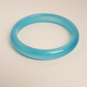 Macro shot of Sky Blue Cat's Eye bangle with smooth translucent finish and polished texture