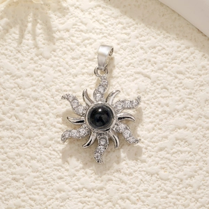 Macro view of silver star necklace pendant with black gemstone and diamond accents
