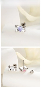 Detail of heart zircon bow earrings with screw back design and purple stone in silver metal