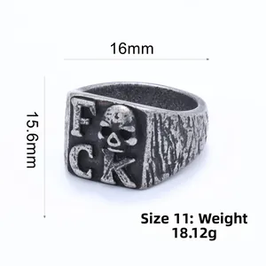 Close-up of vintage punk skull ring with FCK lettering and detailed bark texture