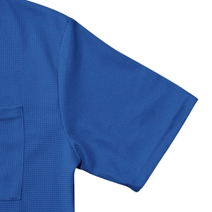 Close-up of blue waffle knit shirt sleeve with pocket detail and neat stitching