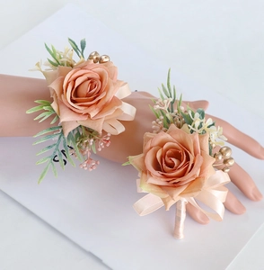 Detailed close-up of champagne silk rose boutonniere and wrist corsage set for weddings
