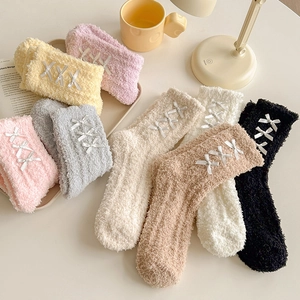 Soft coral fleece sleeping socks with bow decoration in assorted pastel colors