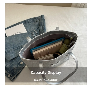 Spacious interior of a metallic silver tote bag showing laptop, umbrella and daily essentials