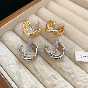 Minimalist twisted metal clip-on earrings in gold and silver finish for non-pierced ears