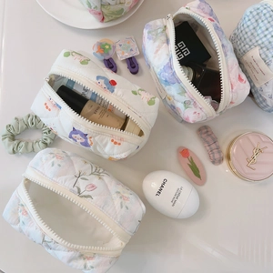 Detailed view of floral quilted cotton makeup bags with top zipper and spacious interior