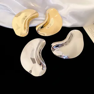 Minimalist irregular wavy earrings in gold and silver finish with polished mirror surface