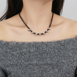 Gothic skull beaded necklace with black crystals and silver skull charms worn by a model