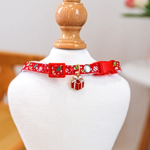 Detailed view of red Christmas pet collar with gift box pendant on a white mannequin