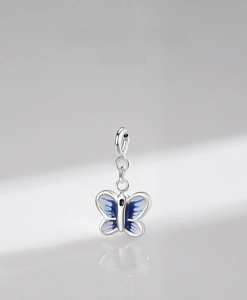 Macro view of 925 sterling silver butterfly pendant with blue and white enamel inlay