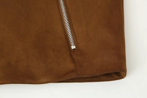 Detail of premium brown suede fabric with metallic silver zipper closure on jacket hem