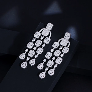 Close-up of sparkling zircon tassel earrings with layered crystals and drop pendants