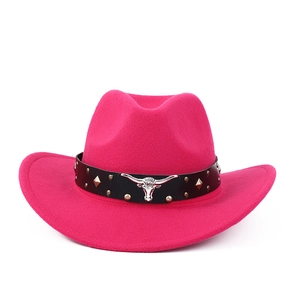Close-up of rose red felt cowboy hat featuring silver bull head metal ornament and rivets