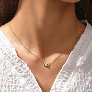 Detail of s925 silver golden necklace with pearl and crystal evil eye pendant